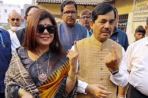 BJP leader Syed Shahnawaz Hussain shows his ink-marked finger after casting a vote during the second and final phase of the state Assembly elections, in Supaul.