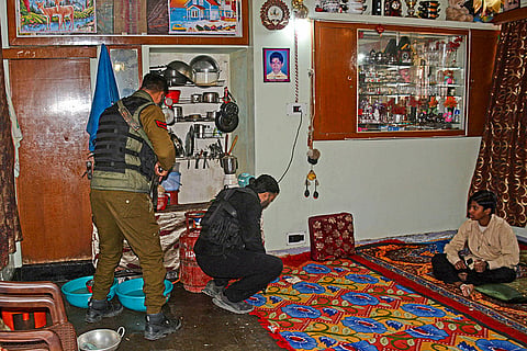 Security personnel conduct searches at a house after receiving inputs of presence of suspected militants, during a high alert following a blast near Red Fort, in Srinagar.