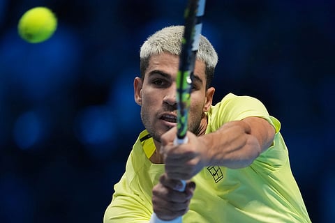 Spain's Carlos Alcaraz returns the ball to United States' Taylor Fritz during their tennis match of the ATP World Tour Finals, in Turin, Italy.