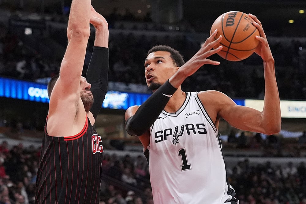 | Photo: AP/Nam Y. Huh : San Antonio Spurs forward Victor Wembanyama, right, drives to the basket against Chicago Bulls center Nikola Vucevic, left, during the second half of an NBA basketball game in Chicago.