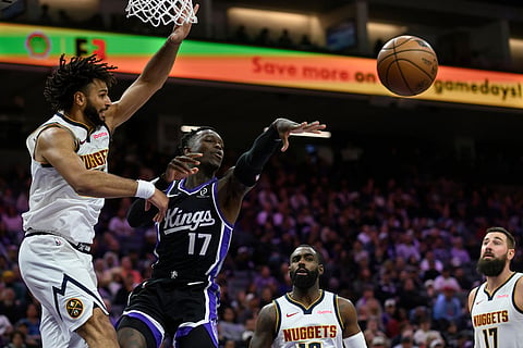 Sacramento Kings guard Dennis Schröder (17) pass the ball past Denver Nuggets guard Jamal Murray (27) during the second half of an NBA basketball game in Sacramento, California.