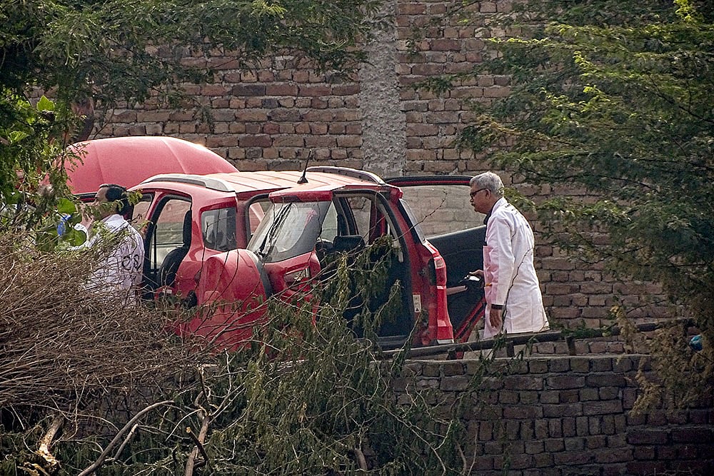 | Photo: PTI : Central Forensic Science Laboratory (CFSL) officials at the site after a red Ford EcoSport car suspected to be linked to the Delhi Red Fort blast case was traced and seized in Faridabad district's Khandawali.