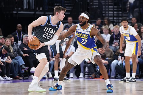 Utah Jazz forward Kyle Filipowski, left, look for the play against Indiana Pacers forward Isaiah Jackson, center, during the second half of an NBA basketball game in Salt Lake City. 