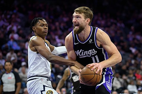 Sacramento Kings forward/center Domantas Sabonis (11) is guarded by Denver Nuggets guard Peyton Watson during the second half of an NBA basketball game in Sacramento, California.