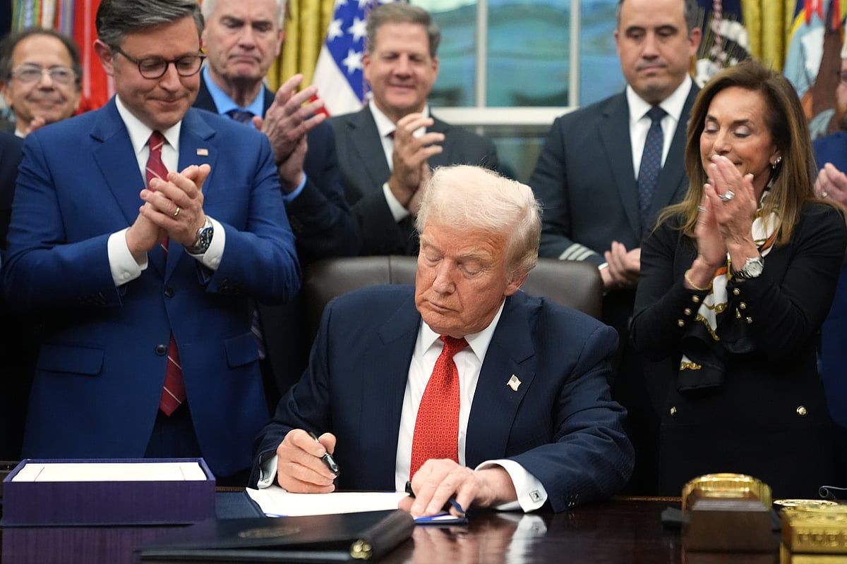 (AP Photo/Jacquelyn Martin) : President Donald Trump signs the funding bill to reopen the government, in the Oval Office of the White House, Wednesday, Nov. 12, 2025, in Washington. 
