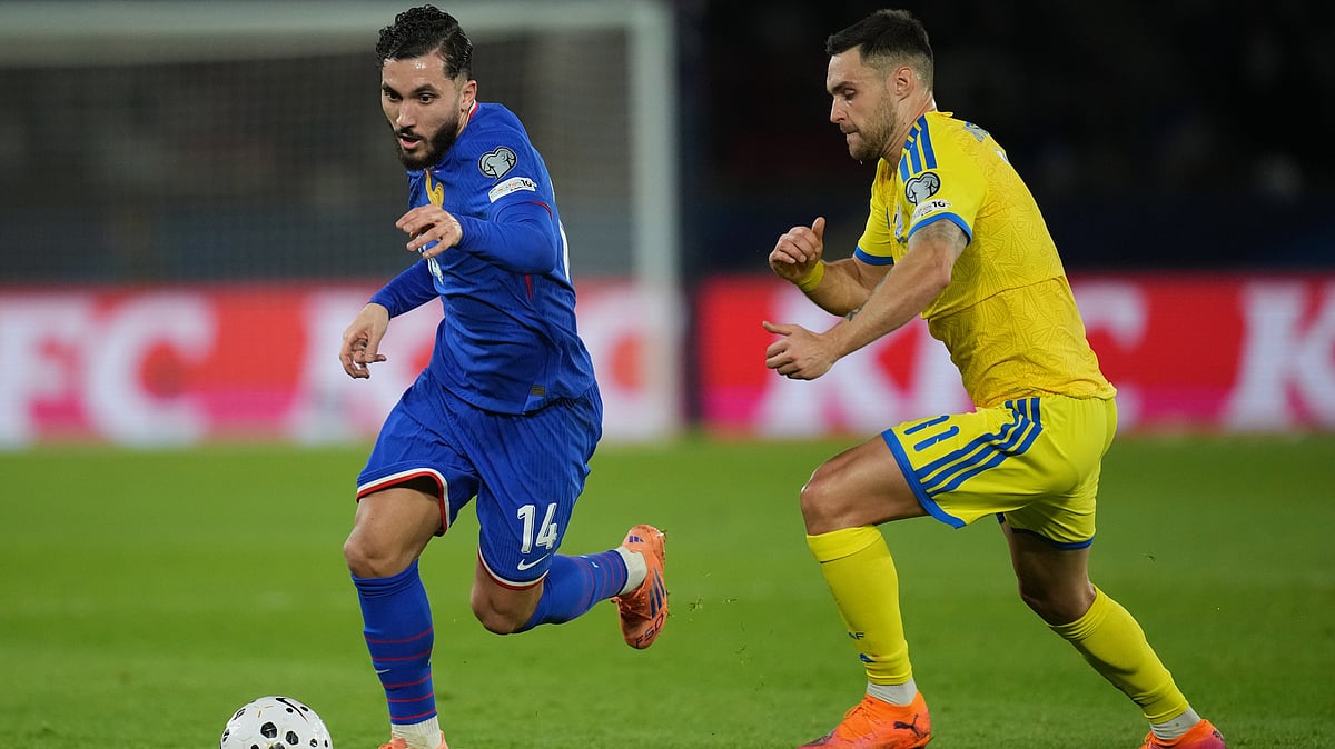AP/Christophe Ena : Rayan Cherki fights for the ball against Ukraine's Oleksii Hutsuliak during a World Cup 2026 group D qualifying soccer match.