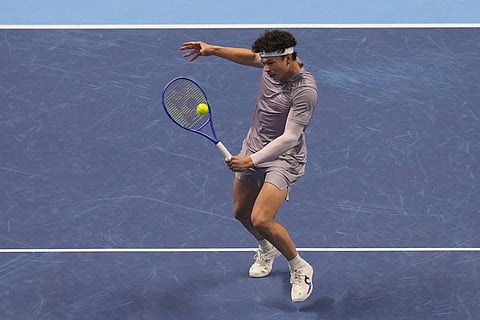 United States' Ben Shelton returns the ball to Canada's Felix Auger-Aliassime during their tennis match of the ATP World Tour Finals, in Turin, Italy.
