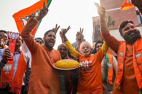 BJP workers celebrate a lead in the Bihar Assembly elections as early trends indicate the NDA crossing the majority mark, at the BJP Headquarters in New Delhi.
