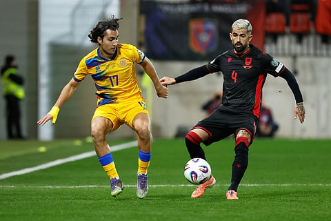 Andorra's Joan Cervos, left, vies for the ball with Albania's Elseid Hysaj during a World Cup 2026 group K qualifying soccer match between Andorra and Albania in Encamp, Andorra.