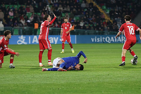 Italy's Raoul Bellanova lies on the pitch after an injury during a group 1, World Cup qualifier soccer match between Moldova and Italy in Chisinau, Moldova.