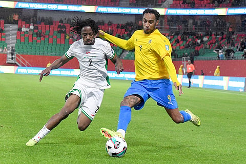 Nigeria's Benjamin Fredrick, left, and Gabon's Pierre-Emerick Aubameyang challenge for the ball during the World Cup 2026 African qualifying semi-final soccer match between Nigeria and Gabon, in Rabat, Morocco.