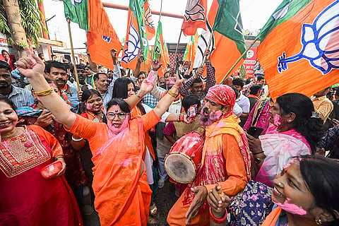 BJP supporters celebrate as the NDA alliance leads during the counting of votes of the Bihar Assembly elections, in Patna.