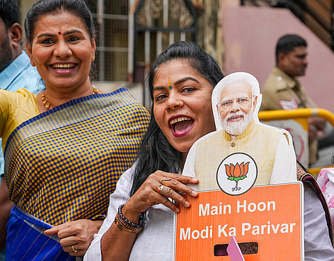 BJP supporters celebrate as the NDA alliance leads during the counting of votes of the Bihar Assembly elections, in Bengaluru, Karnataka.