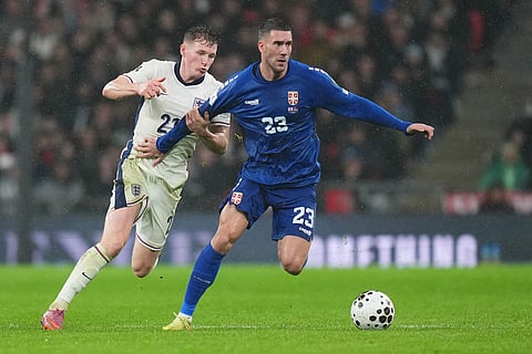 England's Elliot Anderson, left, and Serbia's Dusan Vlahovic fight for the ball during a World Cup qualifier group K soccer match between Serbia and England in London.