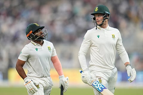 South Africa's captain Temba Bavuma, left, and batting partner Corbin Bosch leave the field at the end of play on the second day of the first cricket test match between India and South Africa in Kolkata.
