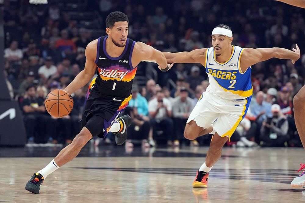 | Photo: AP/Rick Scuteri : Phoenix Suns guard Devin Booker (1) drives on Indiana Pacers guard Andrew Nembhard during the first half of an NBA basketball game in Phoenix. 