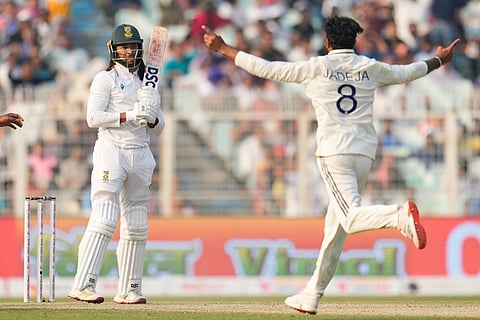 India's Ravindra Jadeja, right, celebrates the dismissal of South Africa's Tony de Zorzi, left, on the second day of the first cricket test match between India and South Africa in Kolkata.