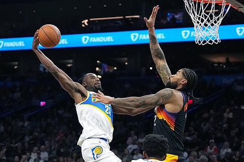 Indiana Pacers guard Aaron Nesmith (23) drives on Phoenix Suns center Nick Richards during the second half of an NBA basketball game in Phoenix.
