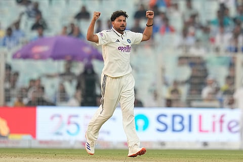 India's Kuldeep Yadav celebrates the dismissal of South Africa's Marco Jansen on the second day of the first cricket test match between India and South Africa in Kolkata.