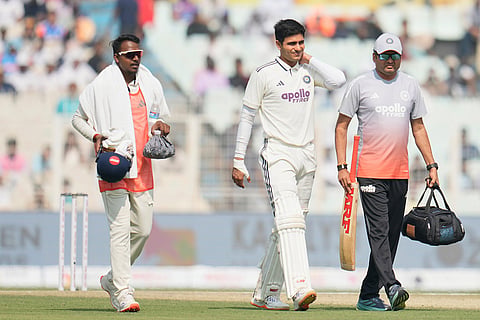 India's captain Shubman Gill, center, leaves the field after retired hurt on the second day of the first cricket test match between India and South Africa in Kolkata.