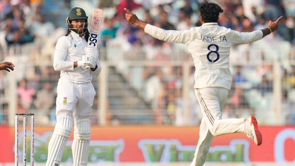 | Photo: AP/Aijaz Rahi : India's Ravindra Jadeja, right, celebrates the dismissal of South Africa's Tony de Zorzi, left, on the second day of the first cricket test match between India and South Africa in Kolkata.