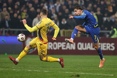 Bosnia's Amar Dedic, right, and Romania's Bogdan Racovitan challenge for the ball during the 2026 World Cup Group H qualifier soccer match between Bosnia and Romania in Zenica, Bosnia and Herzegovina.
