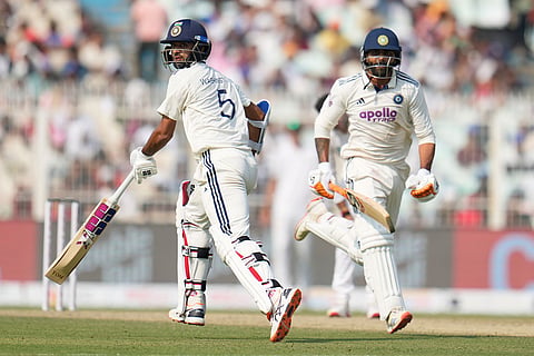 India's Washington Sundar, left, and batting partner Ravindra Jadeja run between the wickets to score on the third day of the first cricket test match between India and South Africa in Kolkata, India.