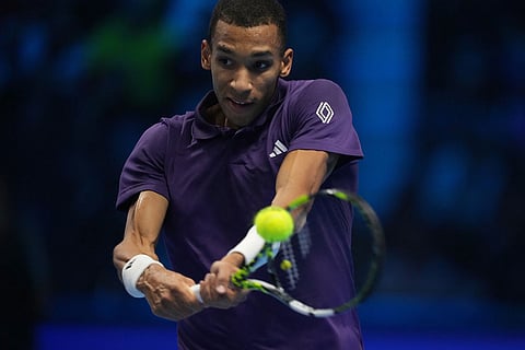 Canada's Felix Auger-Aliassime returns to Spain's Carlos Alcaraz during semifinal tennis match of the ATP World Tour Finals, in Turin, Italy.