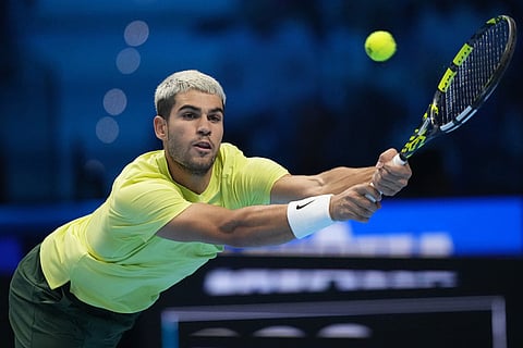 Spain's Carlos Alcaraz returns to Canada's Felix Auger-Aliassime during semifinal tennis match of the ATP World Tour Finals, in Turin, Italy.