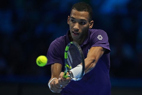 Canada's Felix Auger-Aliassime returns to Spain's Carlos Alcaraz during semifinal tennis match of the ATP World Tour Finals, in Turin, Italy.