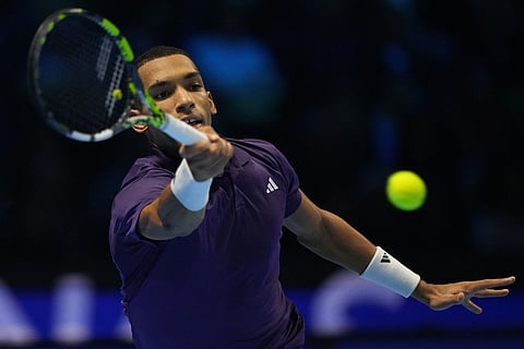 Canada's Felix Auger-Aliassime returns to Spain's Carlos Alcaraz during semifinal tennis match of the ATP World Tour Finals, in Turin, Italy.