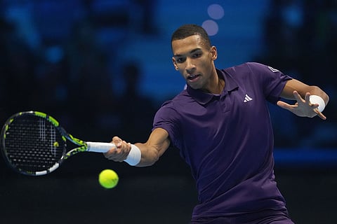 Canada's Felix Auger-Aliassime returns to Spain's Carlos Alcaraz during semifinal tennis match of the ATP World Tour Finals, in Turin, Italy.