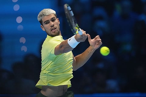 Spain's Carlos Alcaraz returns to Canada's Felix Auger-Aliassime during semifinal tennis match of the ATP World Tour Finals, in Turin, Italy.