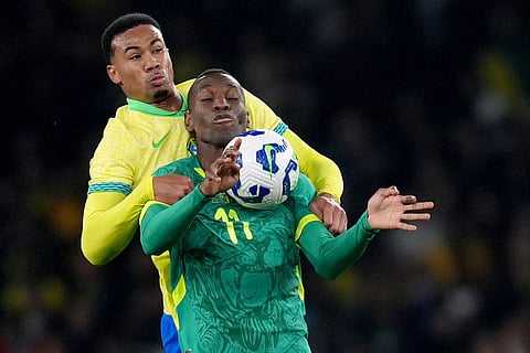 Senegal's Nicolas Jackson, front, and Brazil's Gabriel Magalhaes battle for the ball during an international soccer match between Brazil and Senegal at the Emirates Stadium, London.