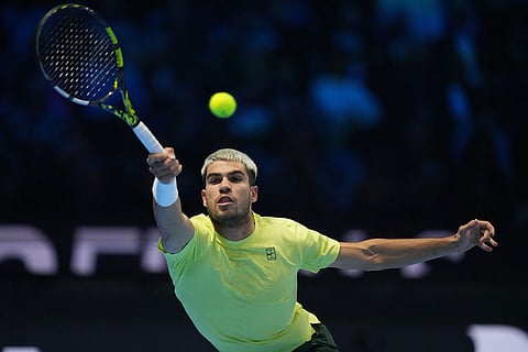 Spain's Carlos Alcaraz returns to Canada's Felix Auger-Aliassime during semifinal tennis match of the ATP World Tour Finals, in Turin, Italy.