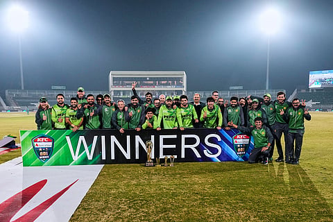 Pakistani players and officials pose for photo with ODI series winning trophy on the end of the third one day international cricket match between Pakistan and Sri Lanka, in Rawalpindi, Pakistan.