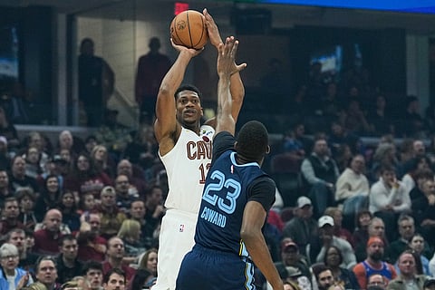 Cleveland Cavaliers forward De'Andre Hunter, left, goes up to shoot over Memphis Grizzlies forward Cedric Coward (23) in the first half of an NBA basketball game in Cleveland. 