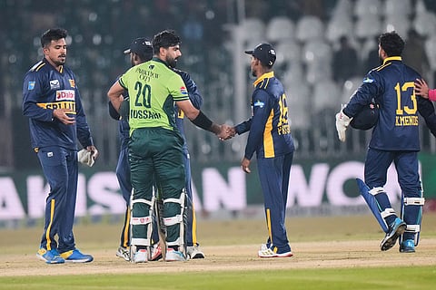 Pakistan's Hussain Talat, third left, shakes hand with Sri Lankan players on the end of the third one day international cricket match between Pakistan and Sri Lanka, in Rawalpindi, Pakistan.