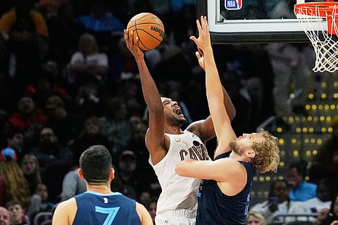Cleveland Cavaliers center Evan Mobley, left, shoots as Memphis Grizzlies center Jock Landale, right, defends in the second half of an NBA basketball game in Cleveland. 