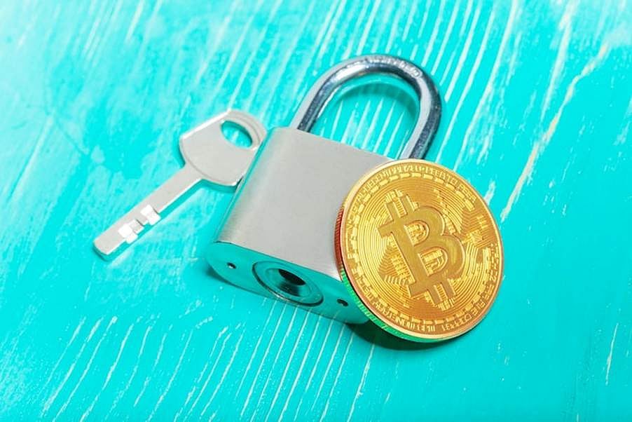 Bitcoin coin, padlock, and key