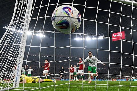 Hungary goalkeeper Denes Dibusz fails to save a shot by Ireland's Troy Parrott who scored his side's third goal during the World Cup 2026 group F qualifying soccer match between Hungary and Ireland in Budapest, Hungary.