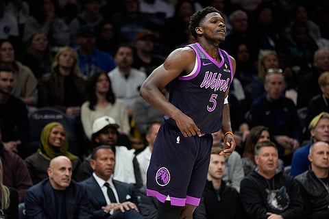 Minnesota Timberwolves guard Anthony Edwards (5) reacts after missing a shot during the first half of an NBA basketball game against the Denver Nuggets in Minneapolis. 