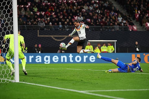 Germany's Leroy Sane, center top, scores a goal during a group A World Cup qualifying soccer match between Germany and Slovakia, in Leipzig, Germany.