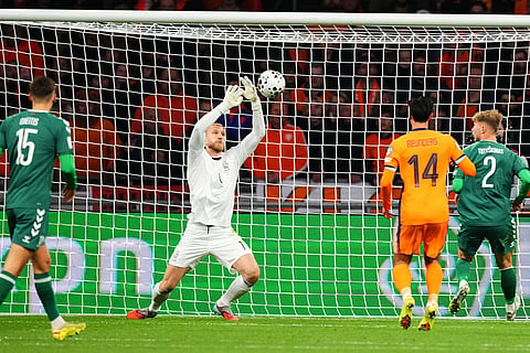 Lithuania's goalkeeper Edvinas Gertmonas, center, makes a save during a World Cup 2026 group G qualifying soccer match between Netherlands and Lithuania in Amsterdam, Netherlands.