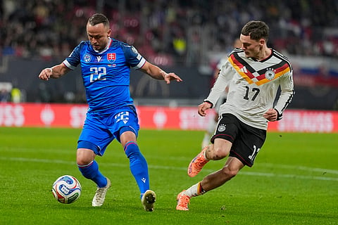 Slovakia's Tanislav Lobotka, left, and Germany's Florian Wirtz fight for the ball during a group A World Cup qualifiying soccer match between Germany and Slovakia in Leipzig, Germany.