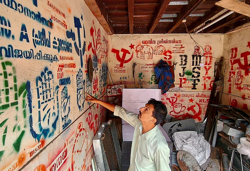 A printing vendor displays models of party symbols in Kerala