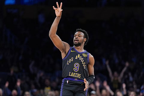 Los Angeles Lakers guard Bronny James (9) reacts after making a three-point basket during the second half of an NBA basketball game against the Utah Jazz  in Los Angeles.