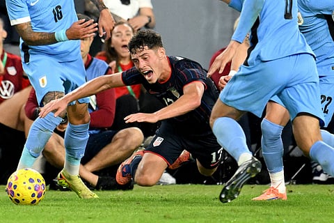 United States' Sebastian Berhalter, center, is tripped during the second half of an international friendly soccer game against Uruguay in Tampa, Fla.