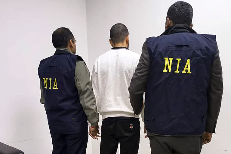 In this image received on Nov. 19, 2025, gangster Anmol Bishnoi, key accused in murder of NCP leader Baba Siddique, accompanied by the National Investigation Agency (NIA) officials during his deportation from the US to India. - Photo: NIA via PTI