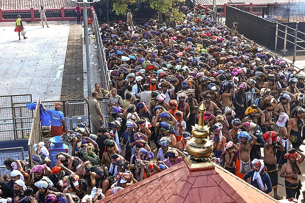 | Photo: PTI : Rush of people to offer prayers at the Sabarimala temple